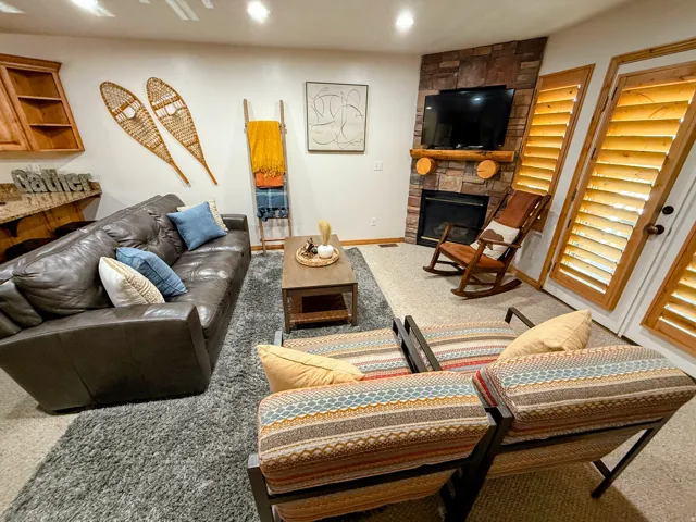Living room featuring a fireplace, light carpet, and recessed lighting