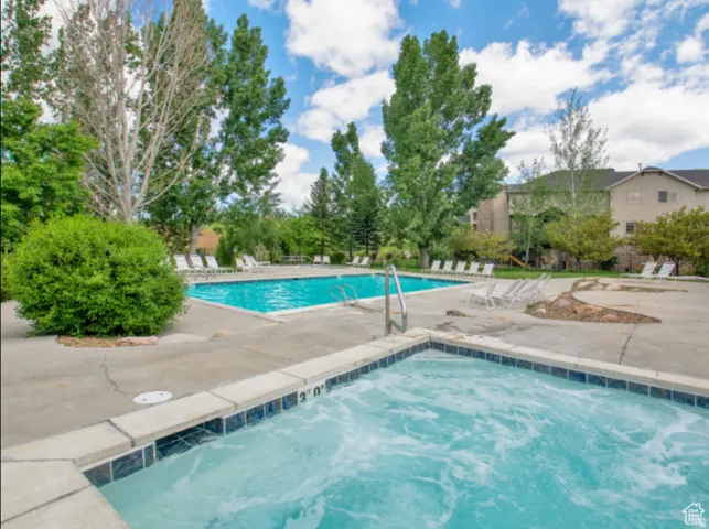 Community pool with a patio