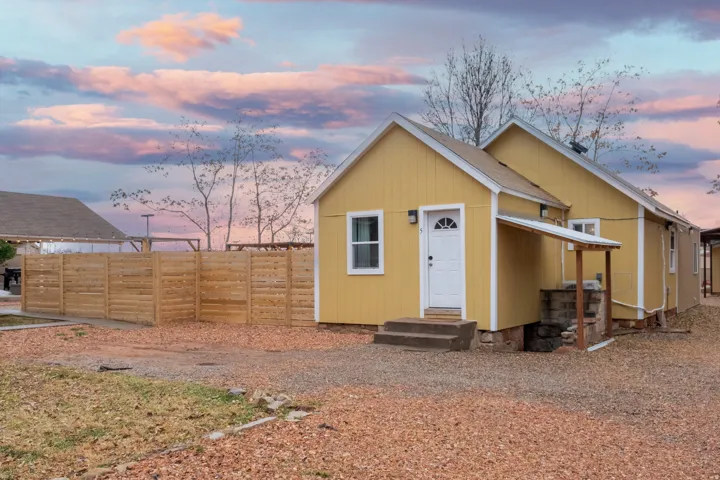 The front of building 2. This unit has 1 unit and an attached garage that has a full bathroom, half bathroom, and laundry hookups. There is extra stroage space under building 2 which the stairs show on the right of the building.