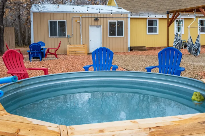 Cowboy pool with filter and a view of the attached garage to building 2 in the background