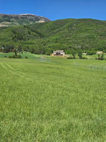 View of mountain backdrop with rural landscape and agricultural land