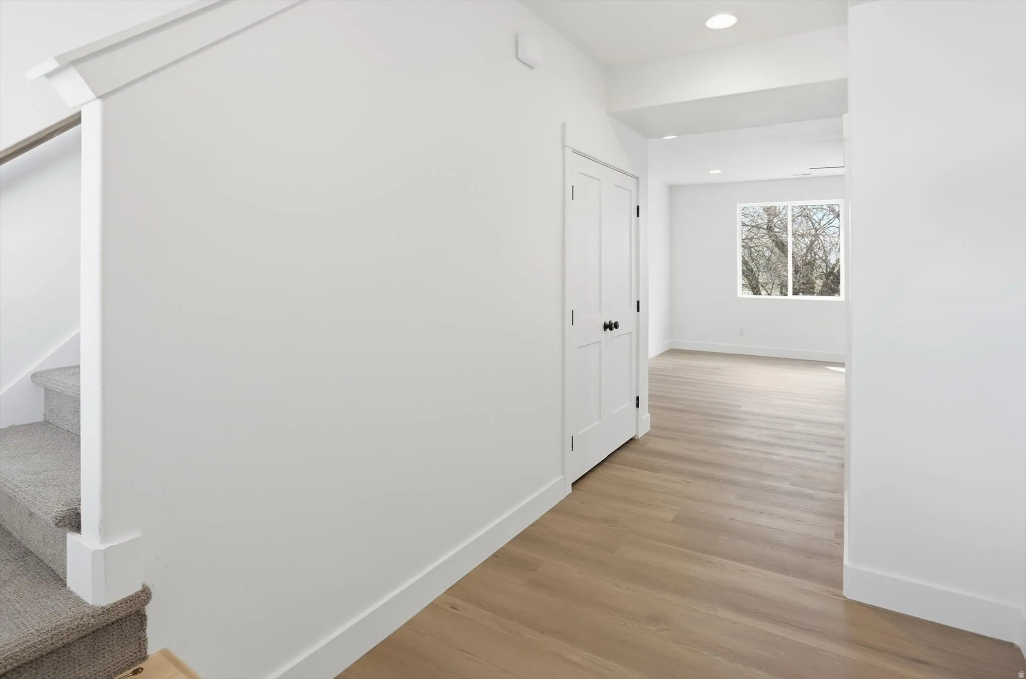 Hallway featuring recessed lighting and light wood-style floors