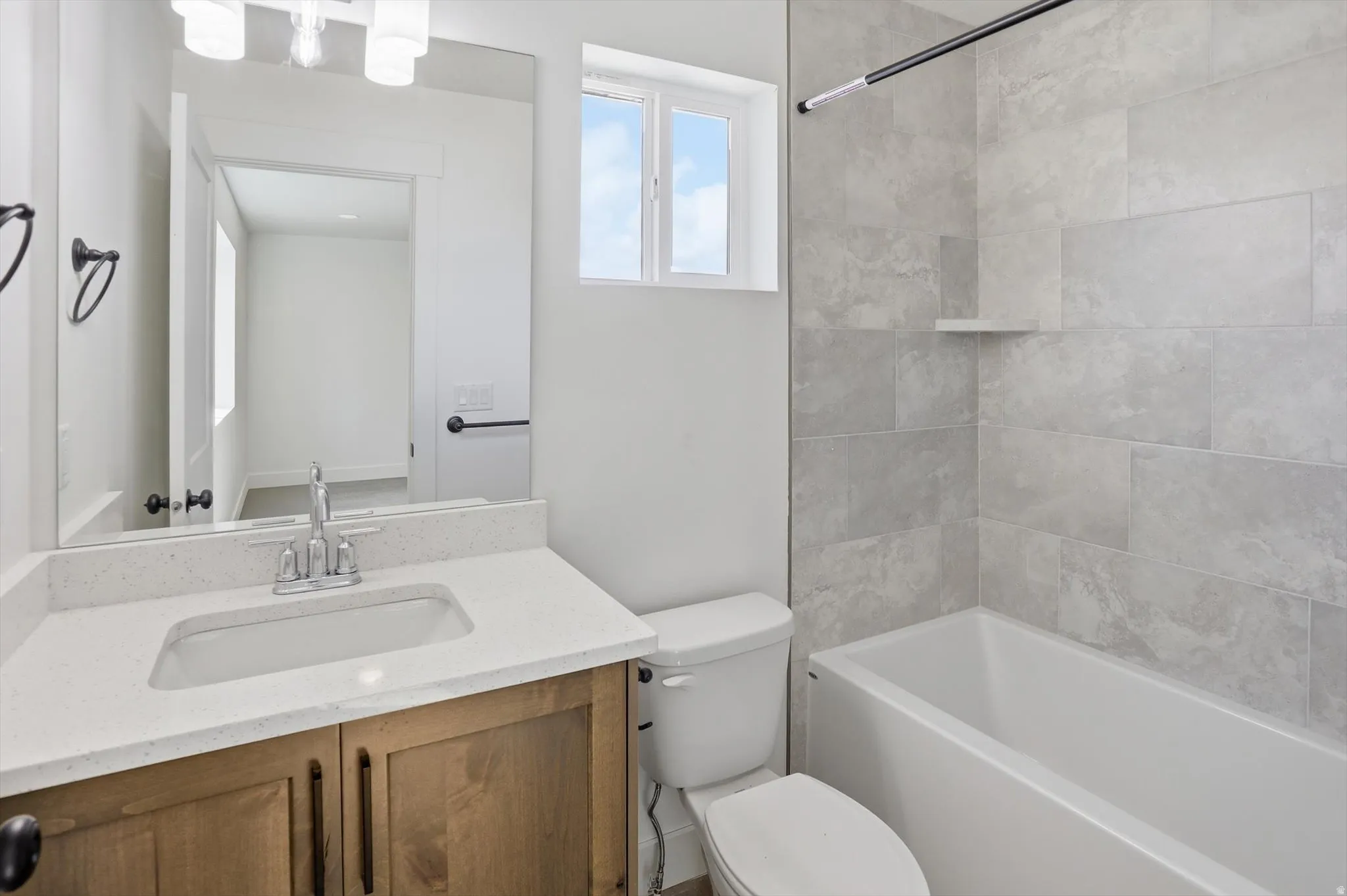 Bathroom with vanity and shower / tub combination