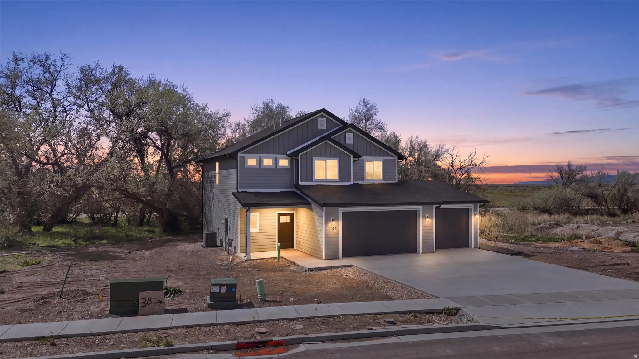 View of front of home featuring concrete driveway, an attached garage, and board and batten siding
