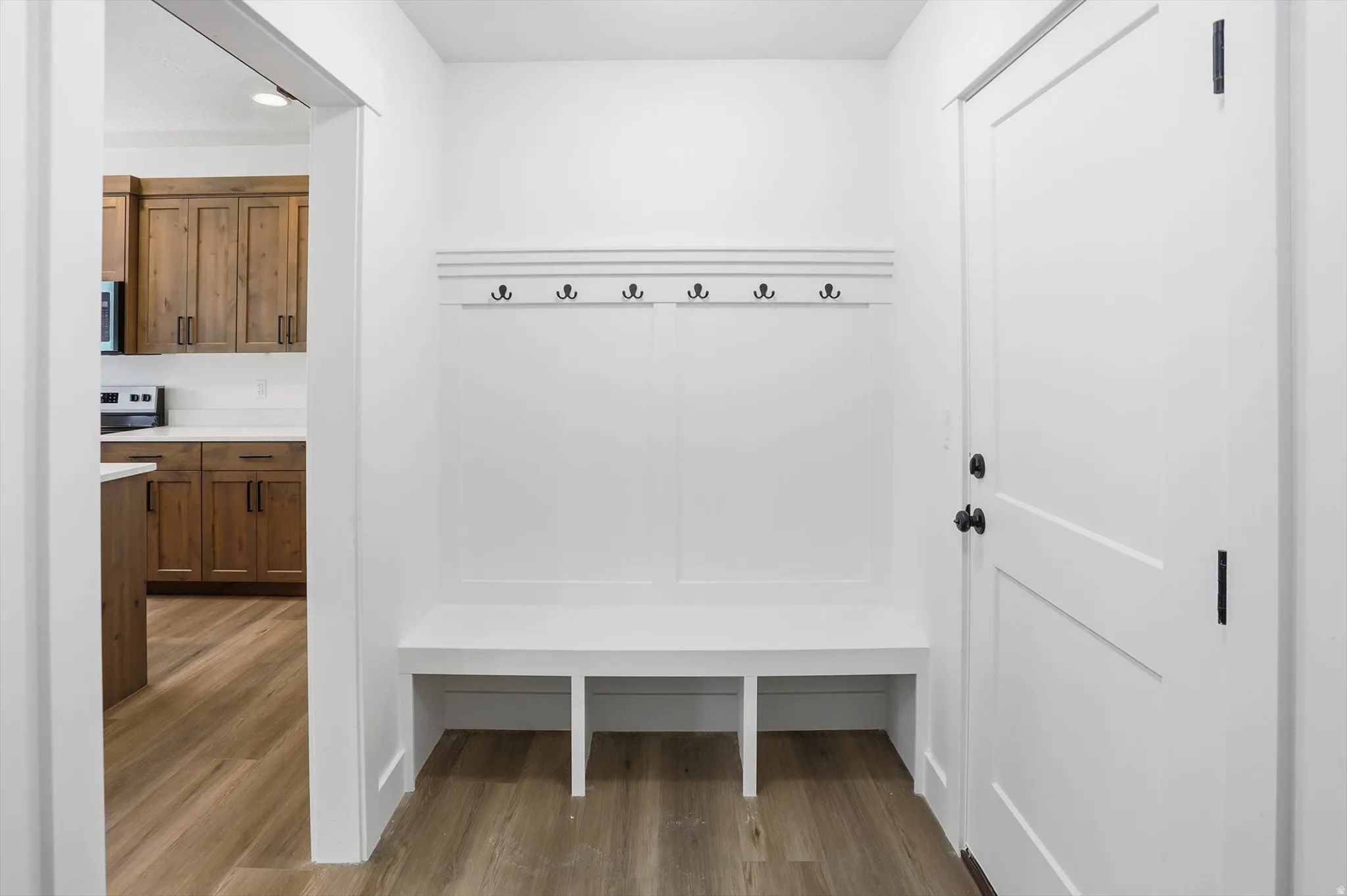 Mudroom with light wood-style flooring and recessed lighting