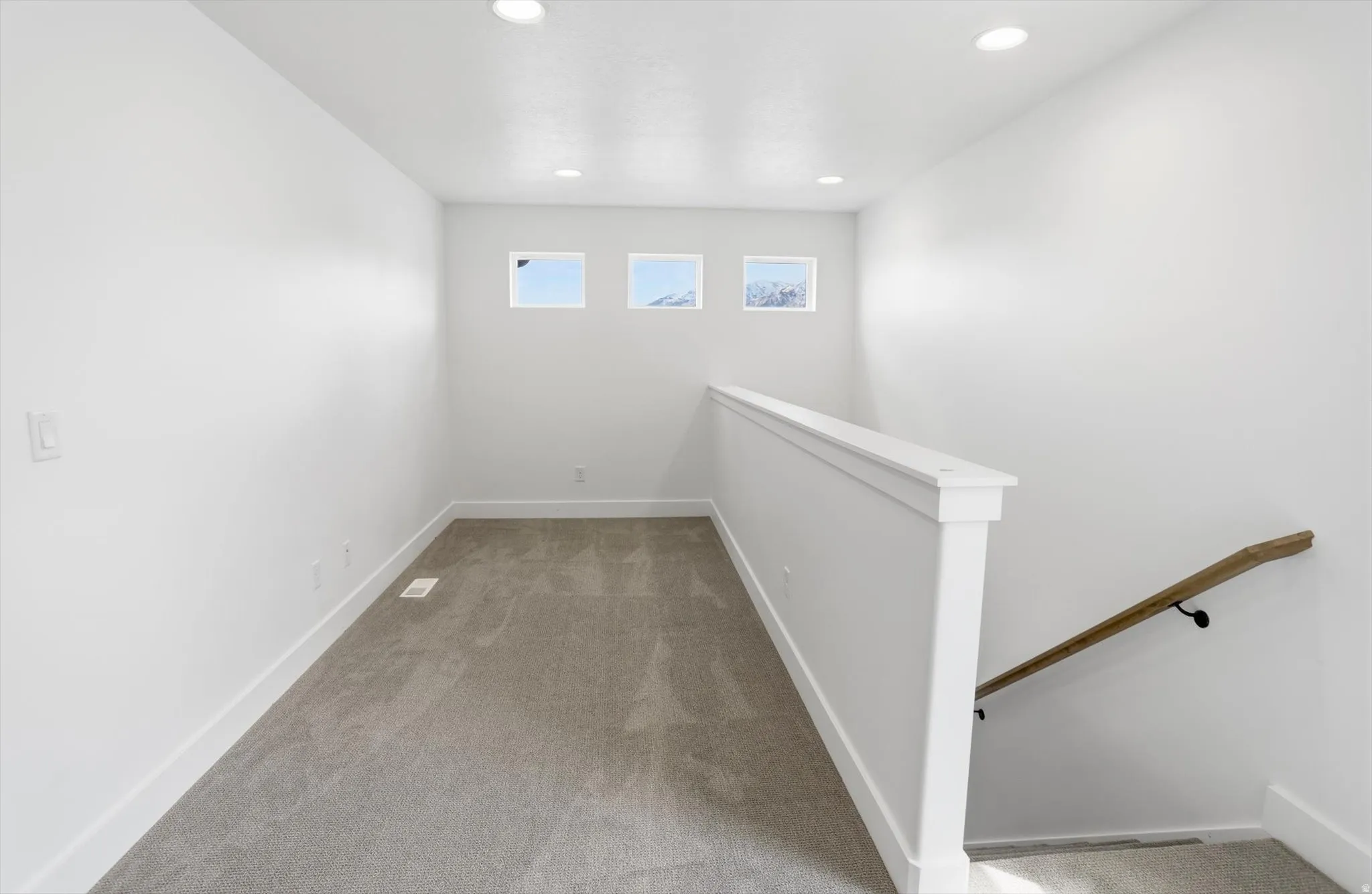 Upstairs Loft area featuring light colored carpet, recessed lighting, and an upstairs landing
