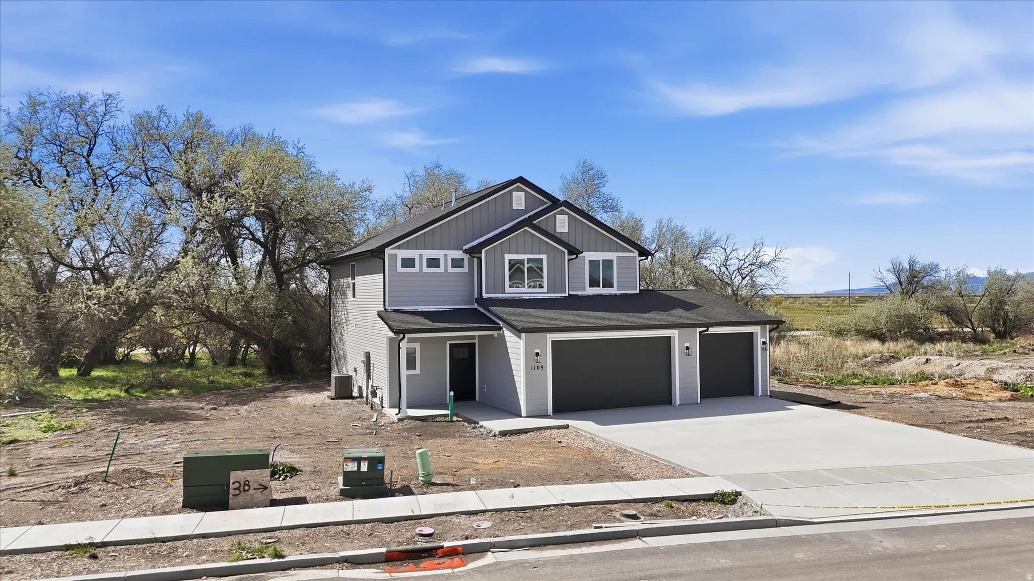 View of front of house featuring concrete driveway, an attached garage, and board and batten siding