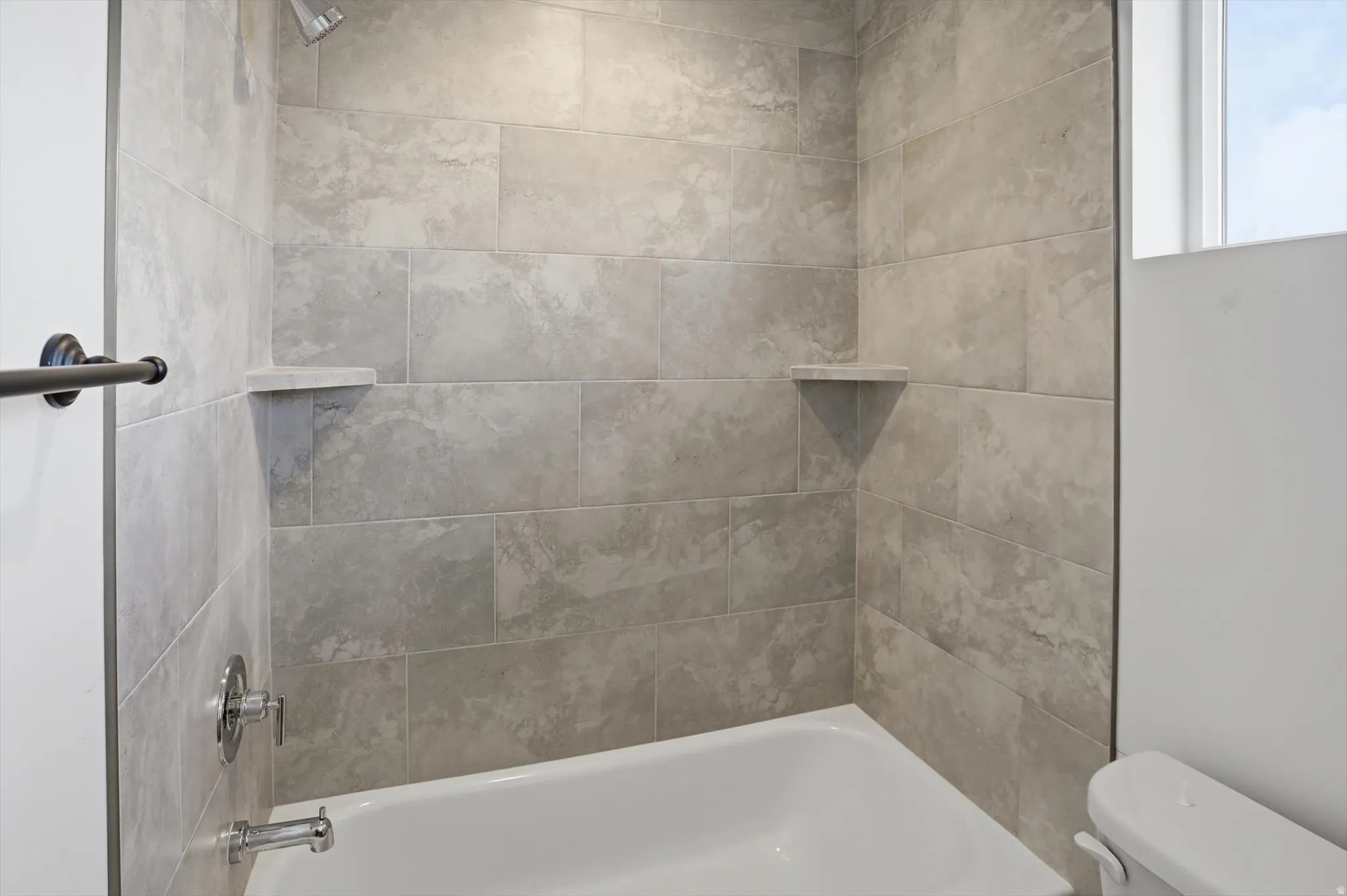 Bathroom featuring toilet and  shower combination