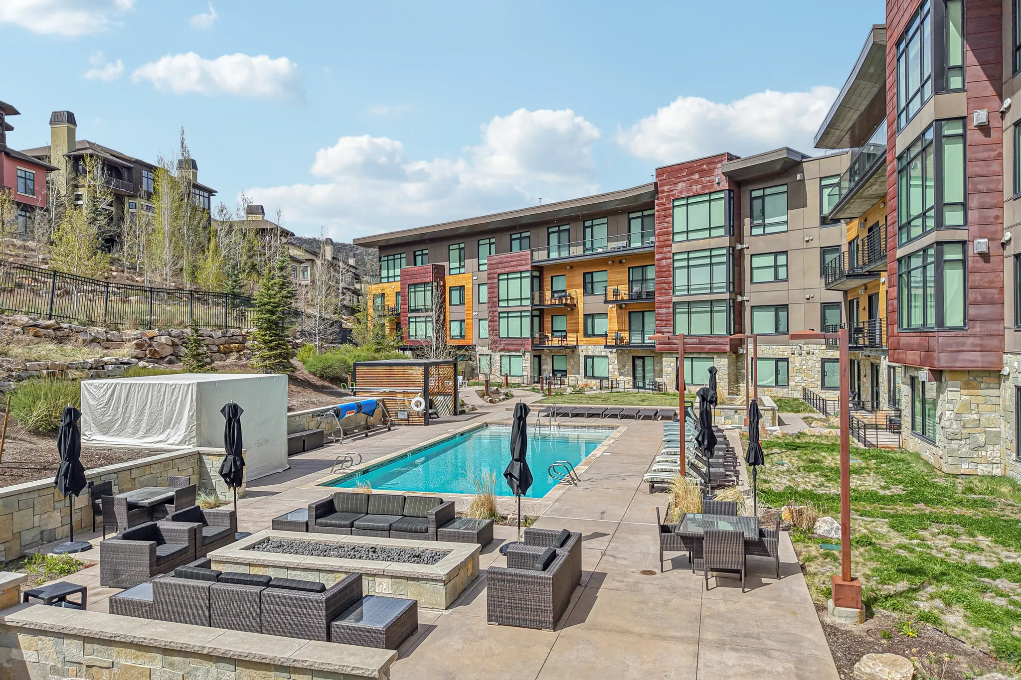 Community pool featuring an outdoor living space with a fire pit and a patio area