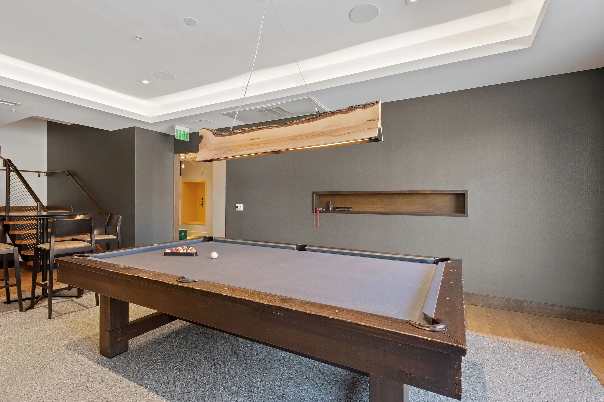 Recreation room with a tray ceiling and billiards