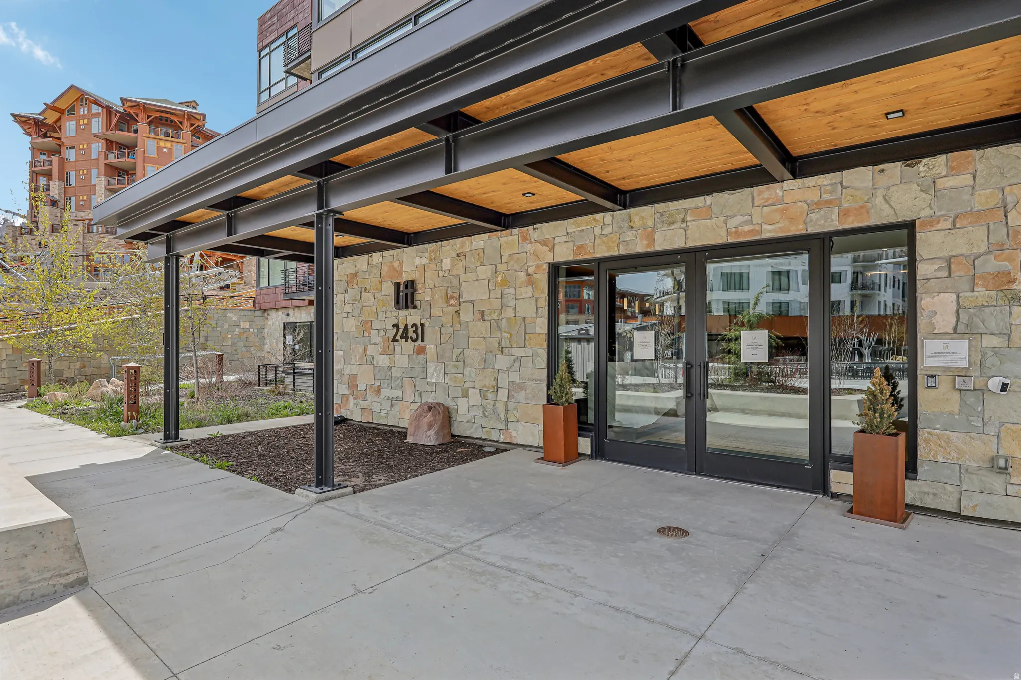 Entrance to property featuring french doors and stone siding