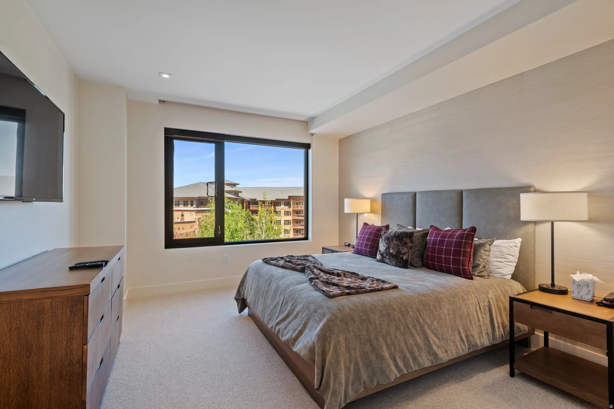 Bedroom with light carpet and baseboards