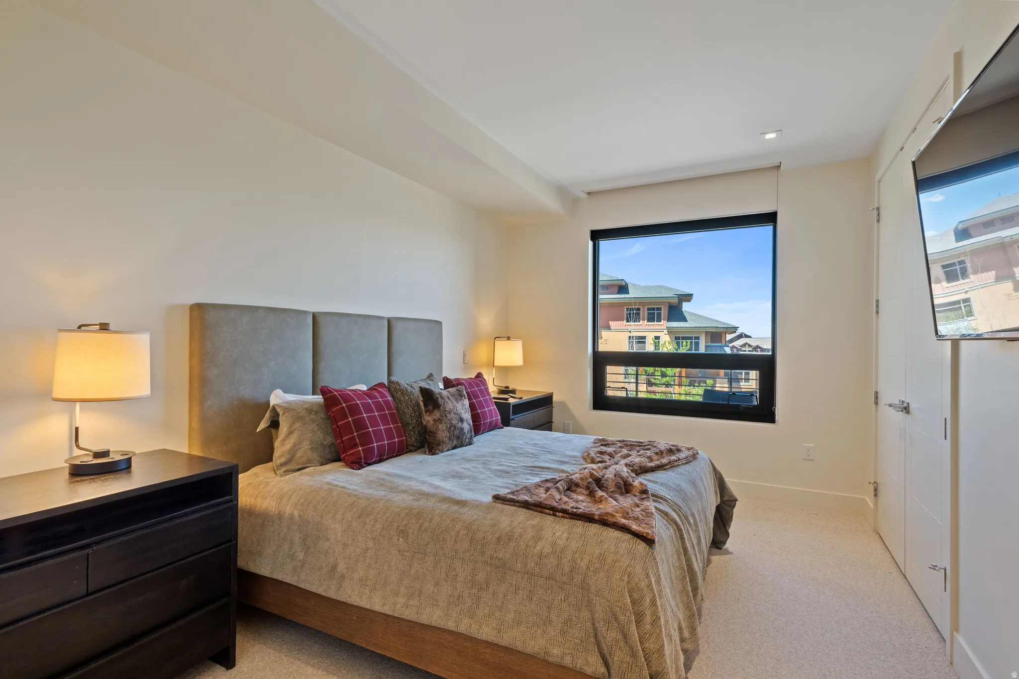 Bedroom featuring light colored carpet and baseboards