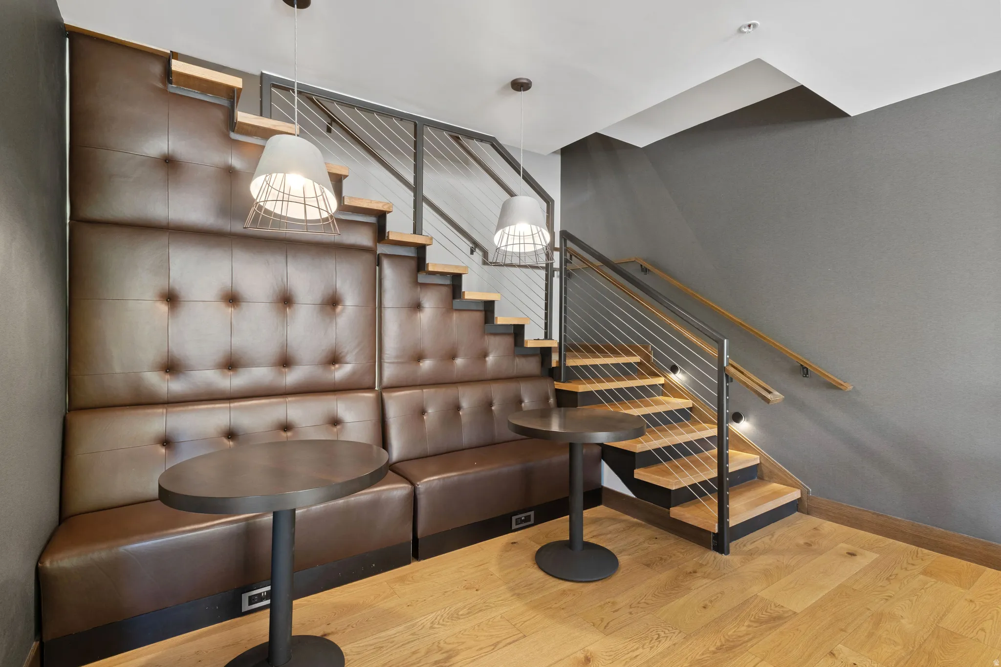 Stairway with wood finished floors and baseboards