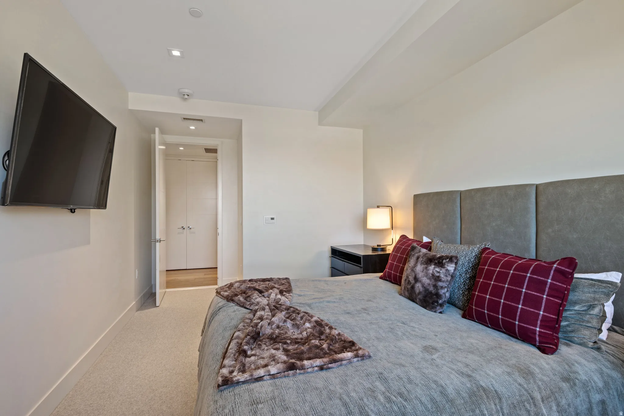 Bedroom featuring light carpet and baseboards