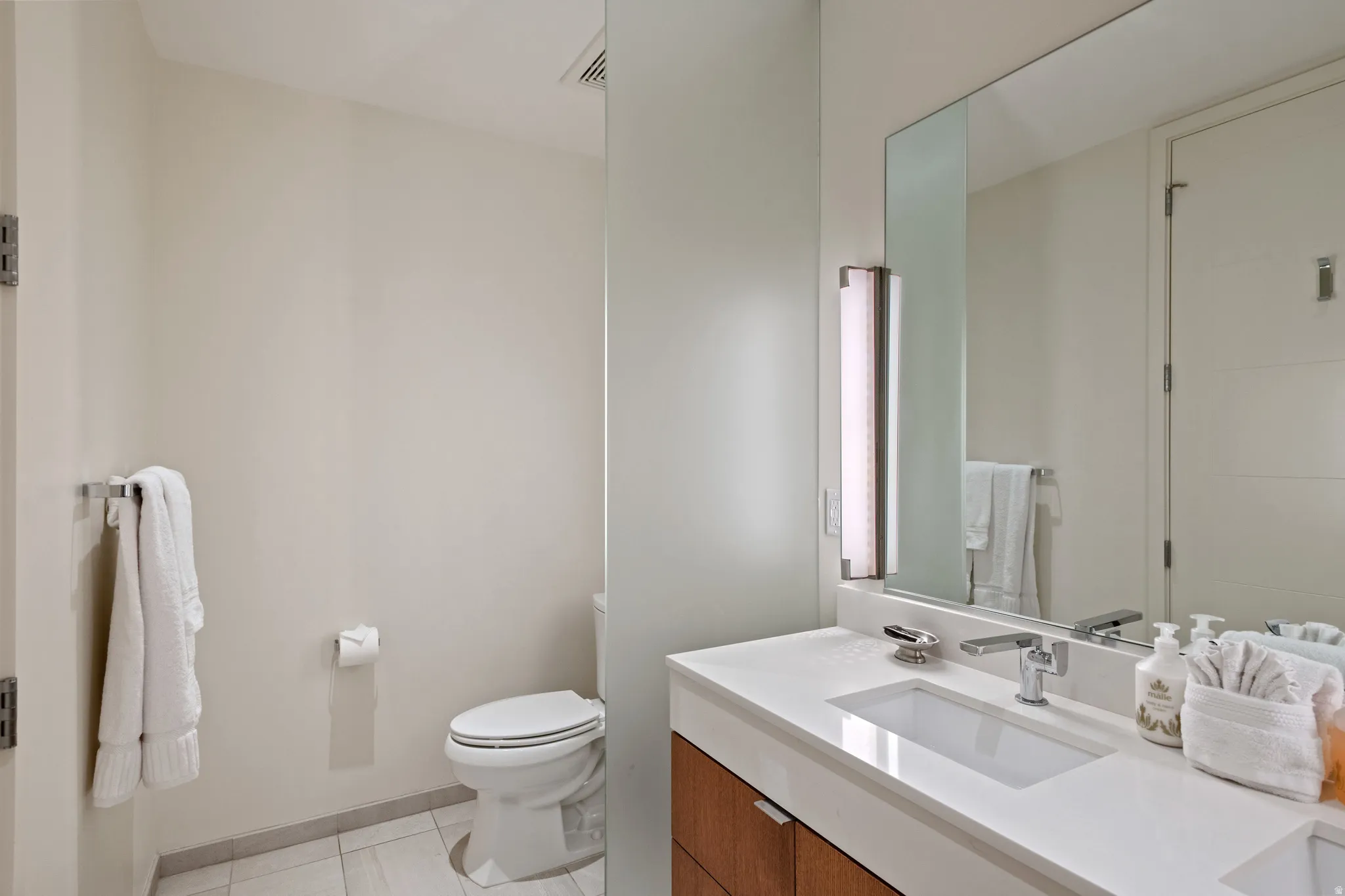 Bathroom with vanity and light tile patterned flooring