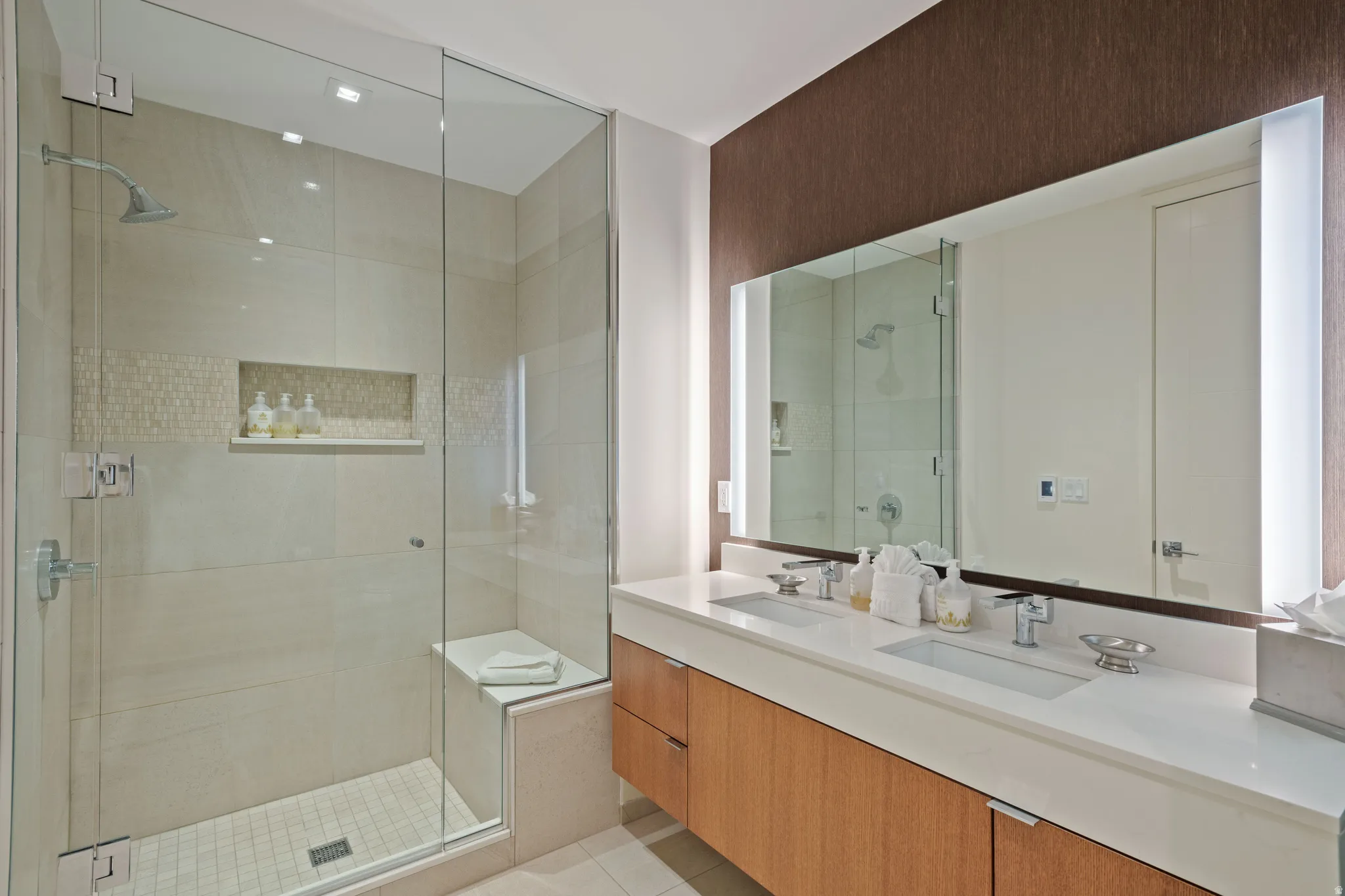 Full bathroom with double vanity and a shower stall