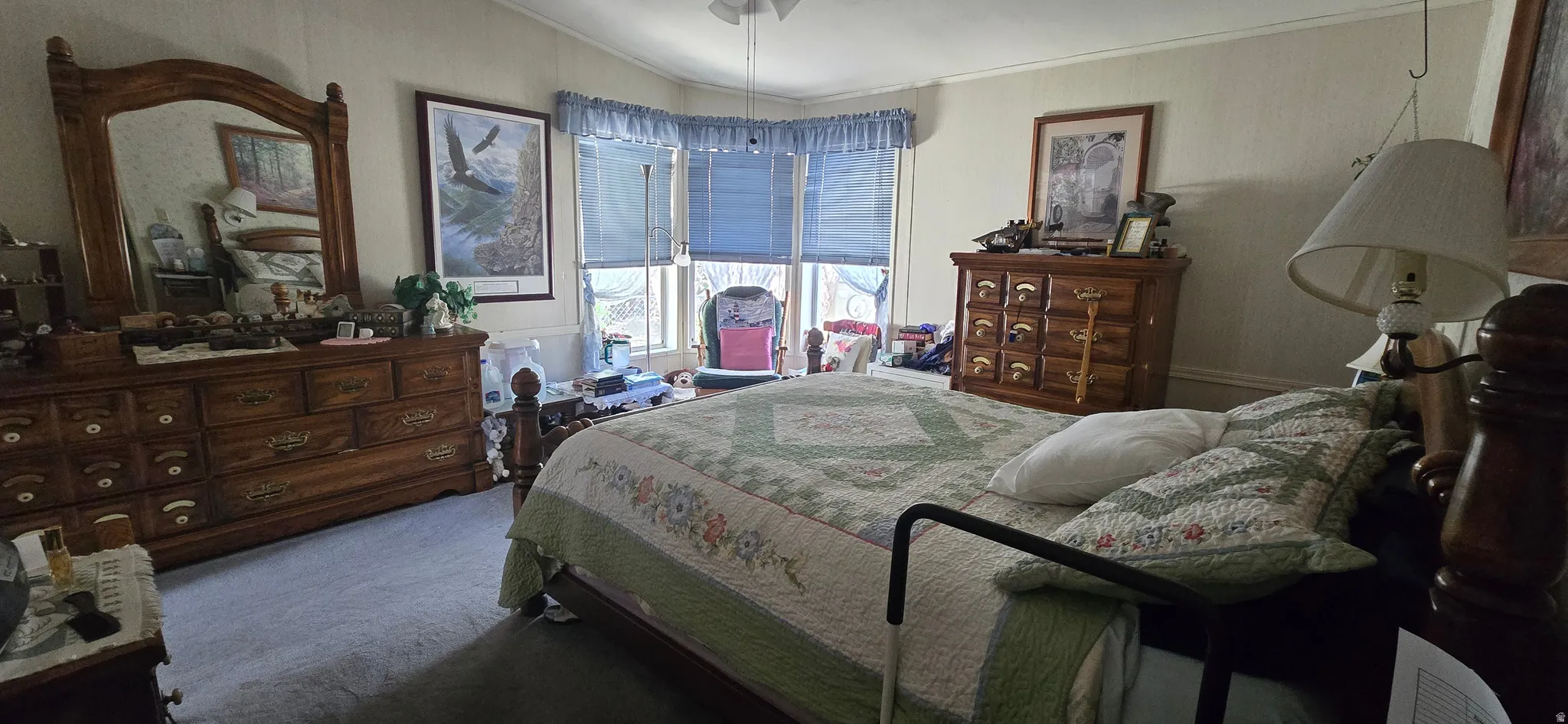 Bedroom featuring dark carpet, crown molding, and lofted ceiling