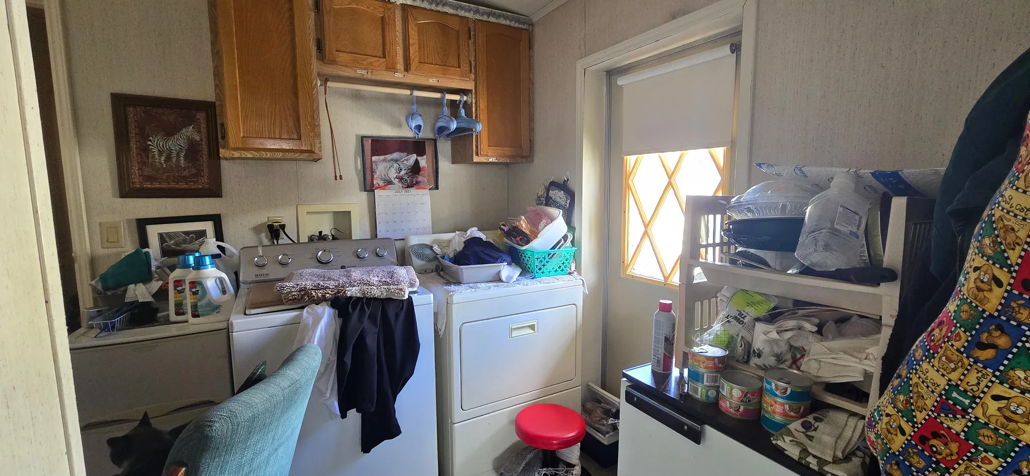 Laundry area featuring washing machine and clothes dryer and cabinet space