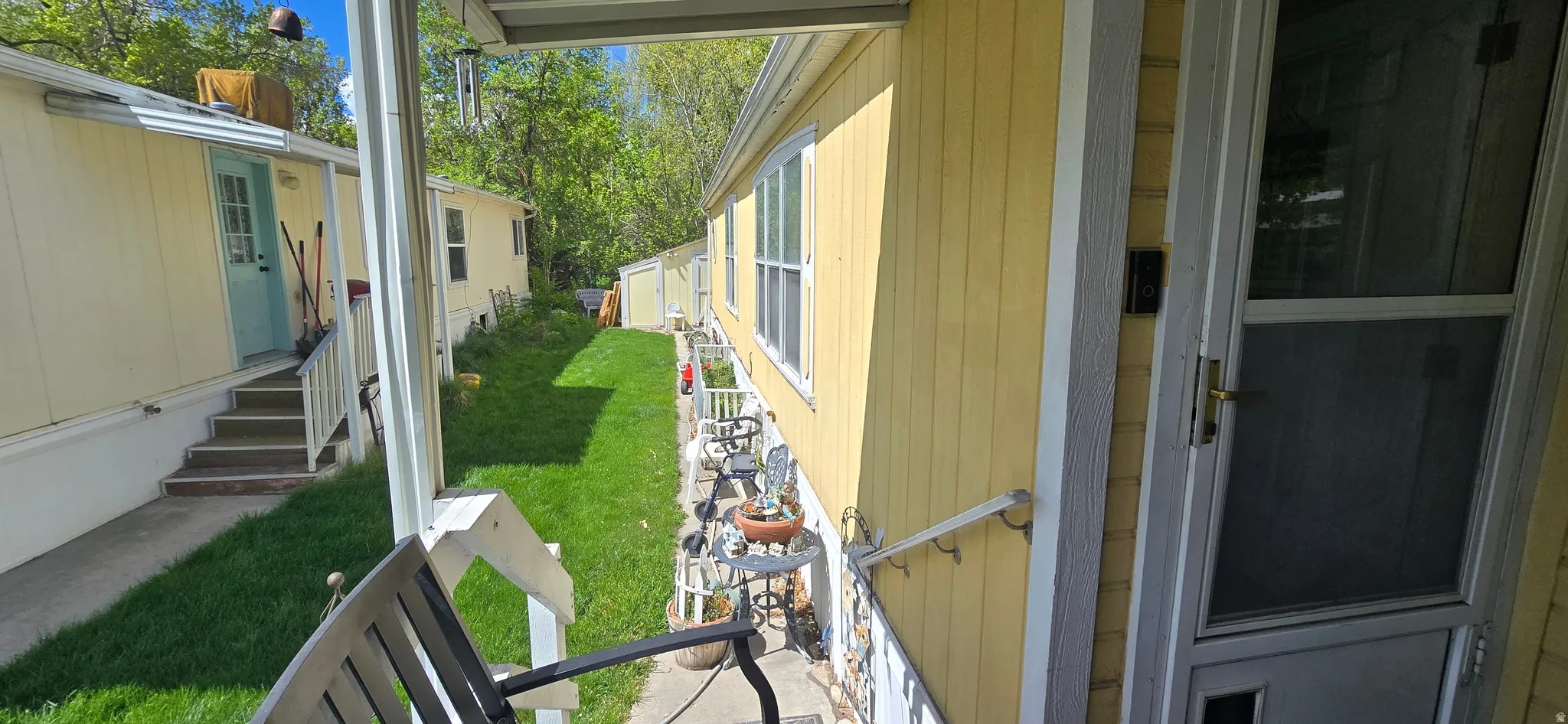 View of green lawn featuring entry steps