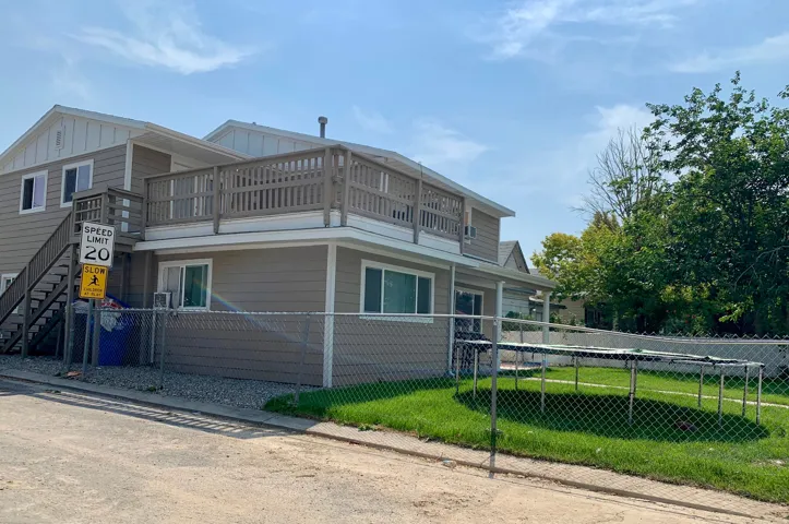 View of property exterior featuring board and batten siding and stairway