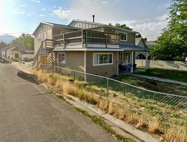 View of front facade featuring a fenced front yard and board and batten siding