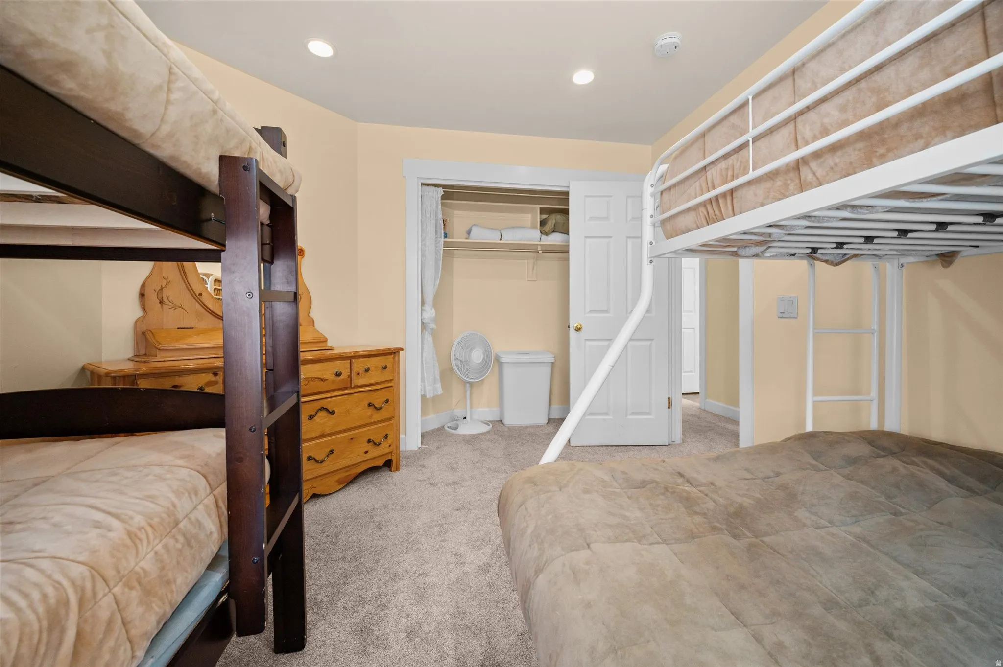 Guest bedroom sleeps six comfortably, with closet and dresser.