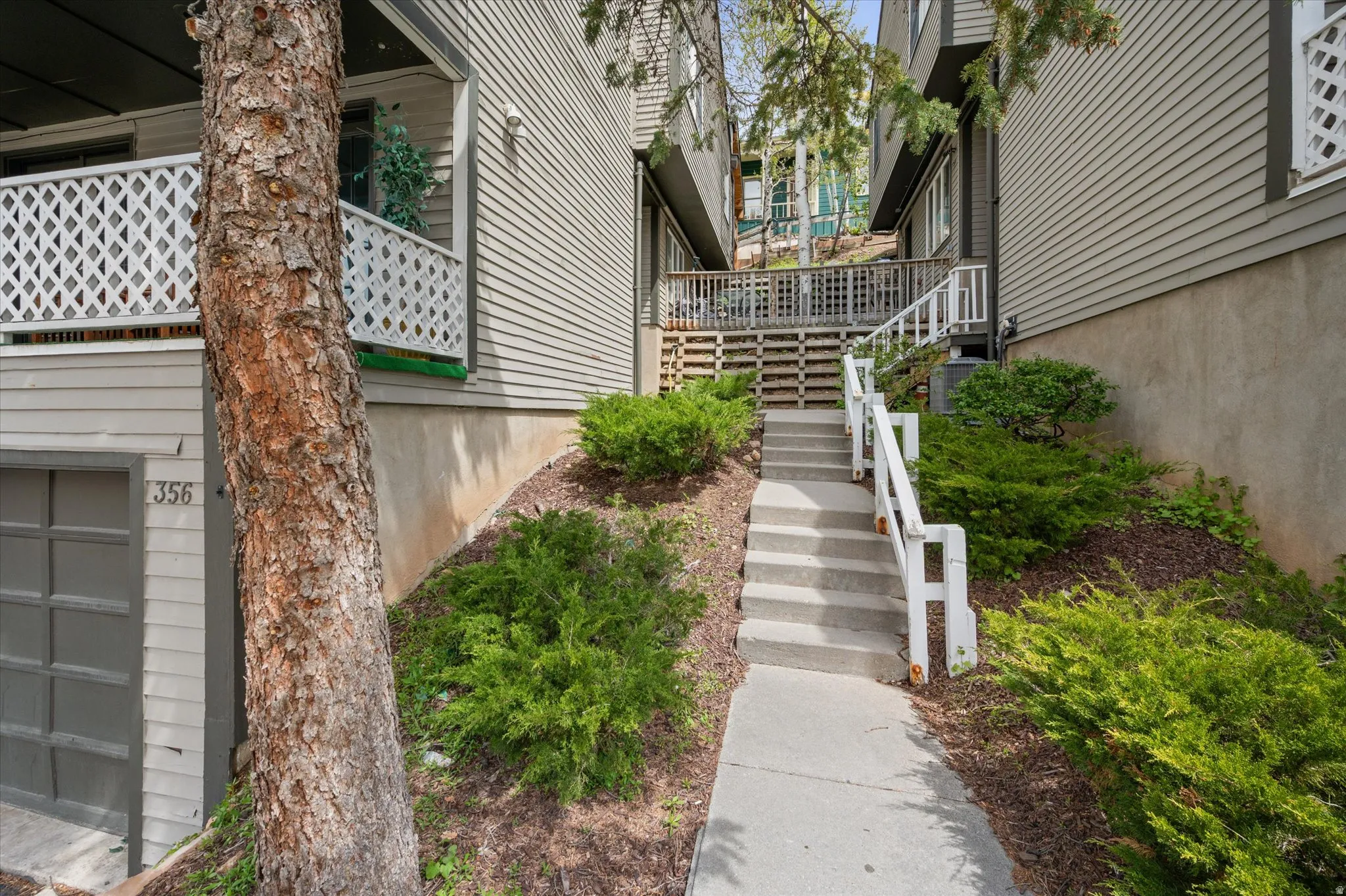 Exterior view of garage and stairs to front entry.