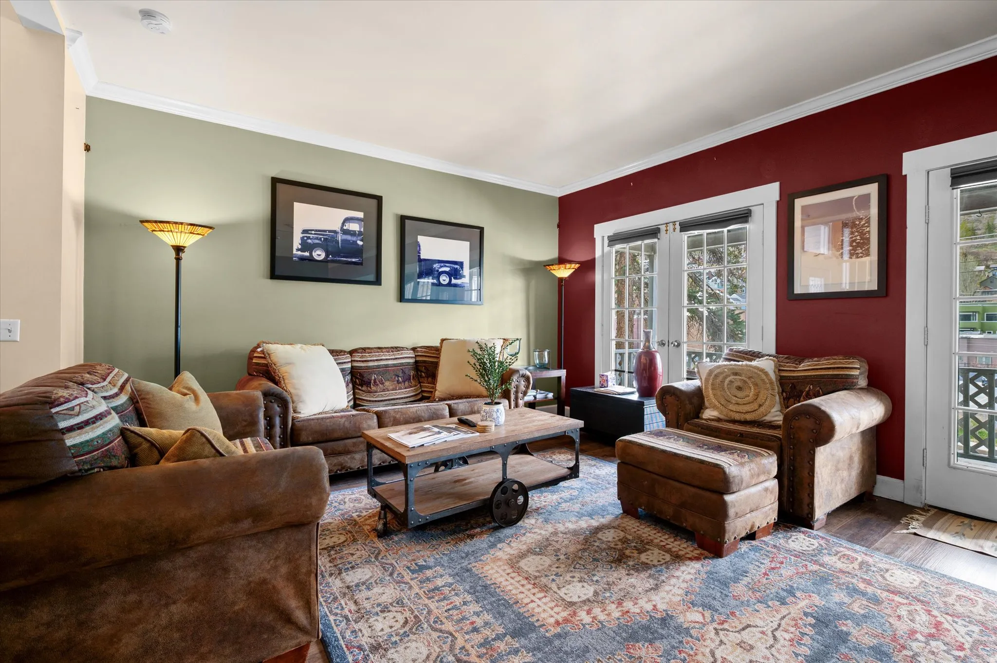 Family room with crown molding, LVP flooring, and french doors to exquisite ski mountain views.