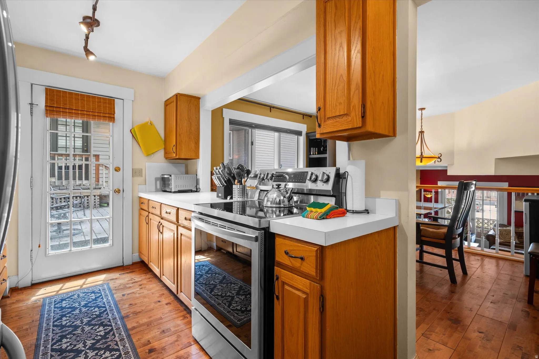 Kitchen with stainless steel appliances, light countertops, and lots of natural light.