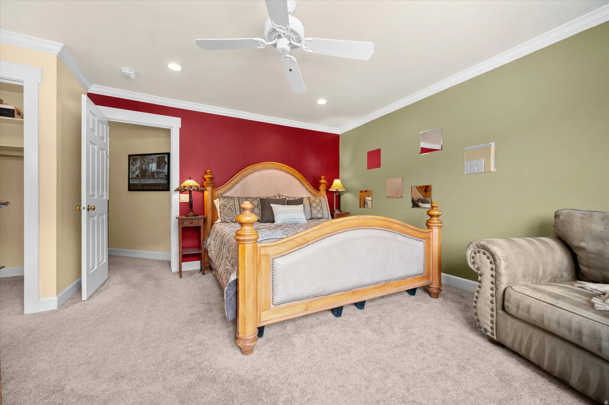 Owner's suite bedroom with plush carpet, crown molding, recessed lighting, and spectacular mountain views.