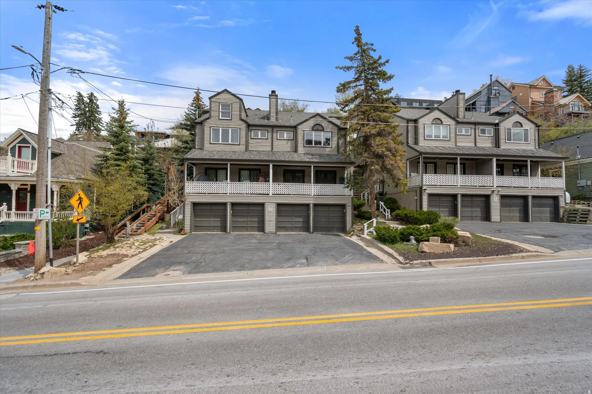 View of front of home featuring asphalt driveway, covered porch, an attached garage, and mountain view.