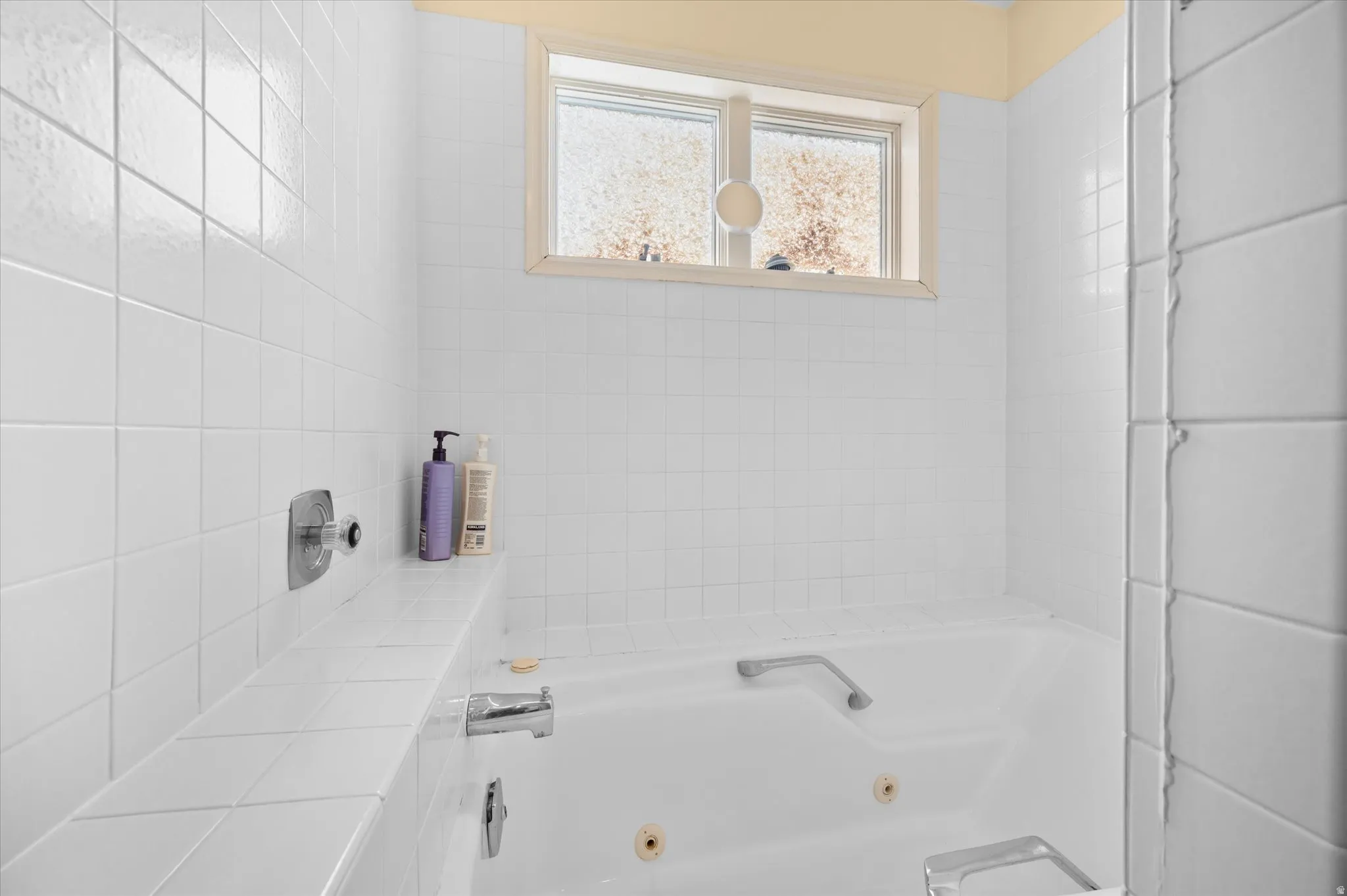 Owner's suite bathroom with a jetted tub and shower head.