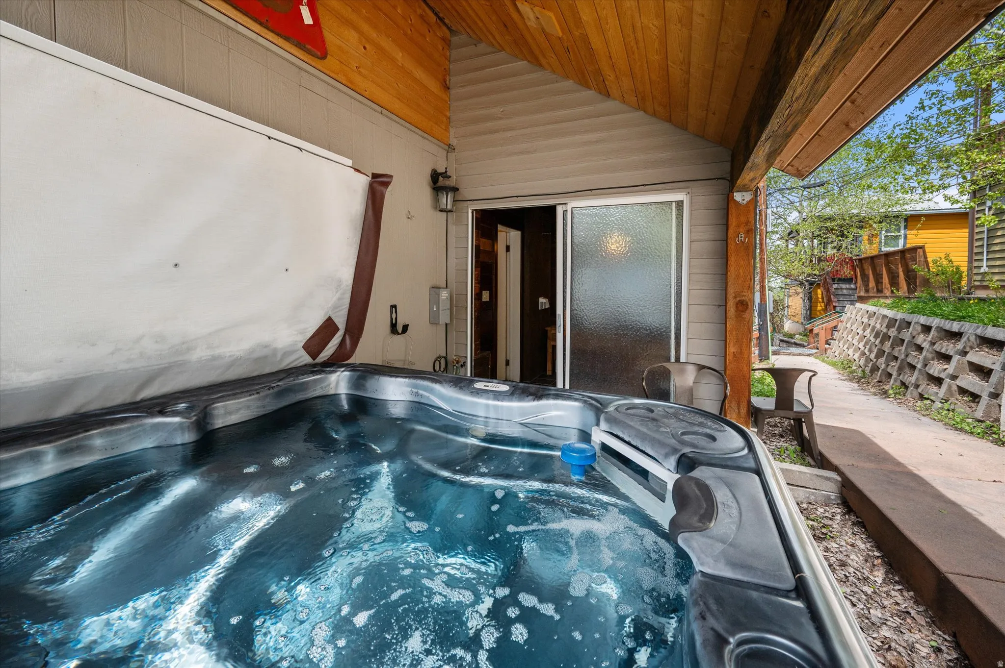 View of patio / terrace with a hot tub