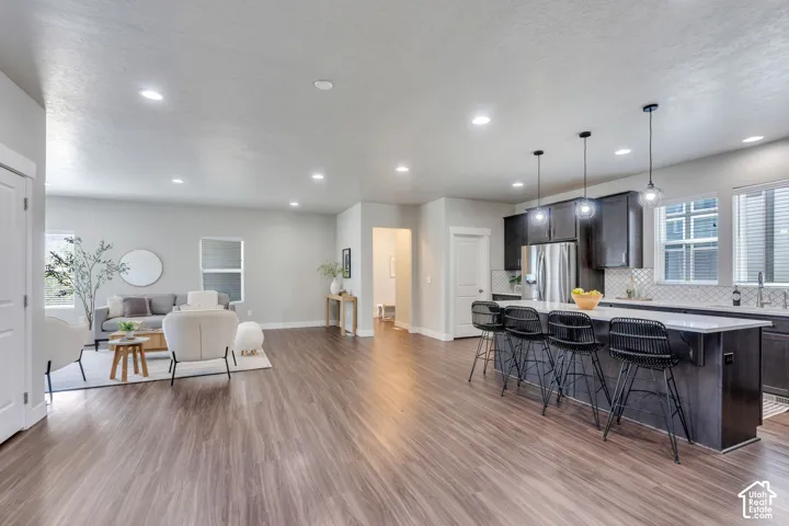 Expansive wood-finish flooring throughout the open-concept living area