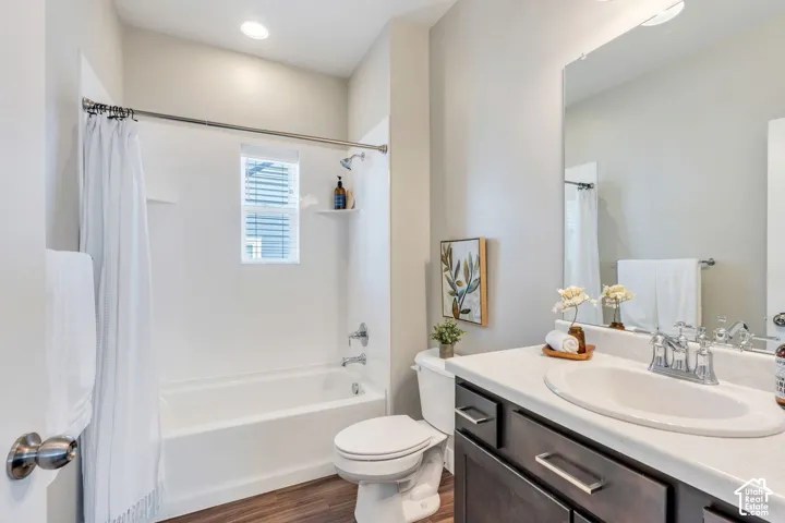 Contemporary bathroom featuring a dual-sink vanity with dark cabinetry and quartz countertop, chrome faucetry, and rectangular vessel sinks