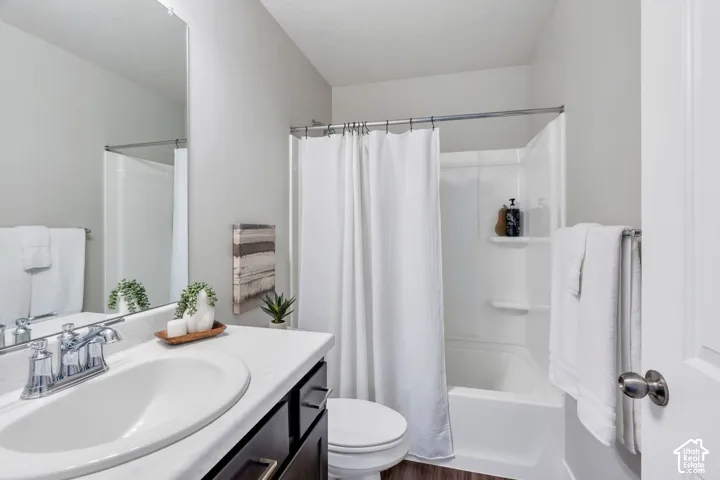 Vanity with an integrated sink, polished chrome faucet, and dark wood-finish cabinetry
