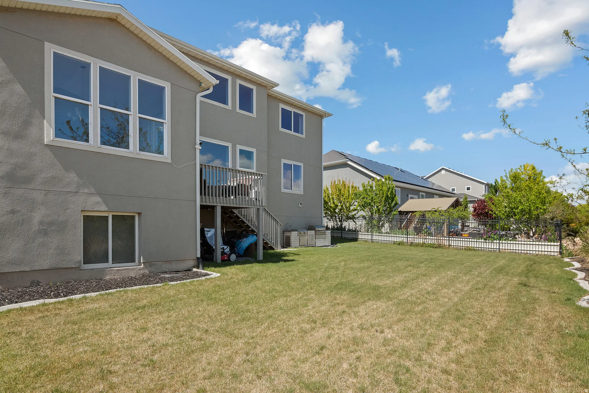 Fenced yard featuring stairs and a wooden deck