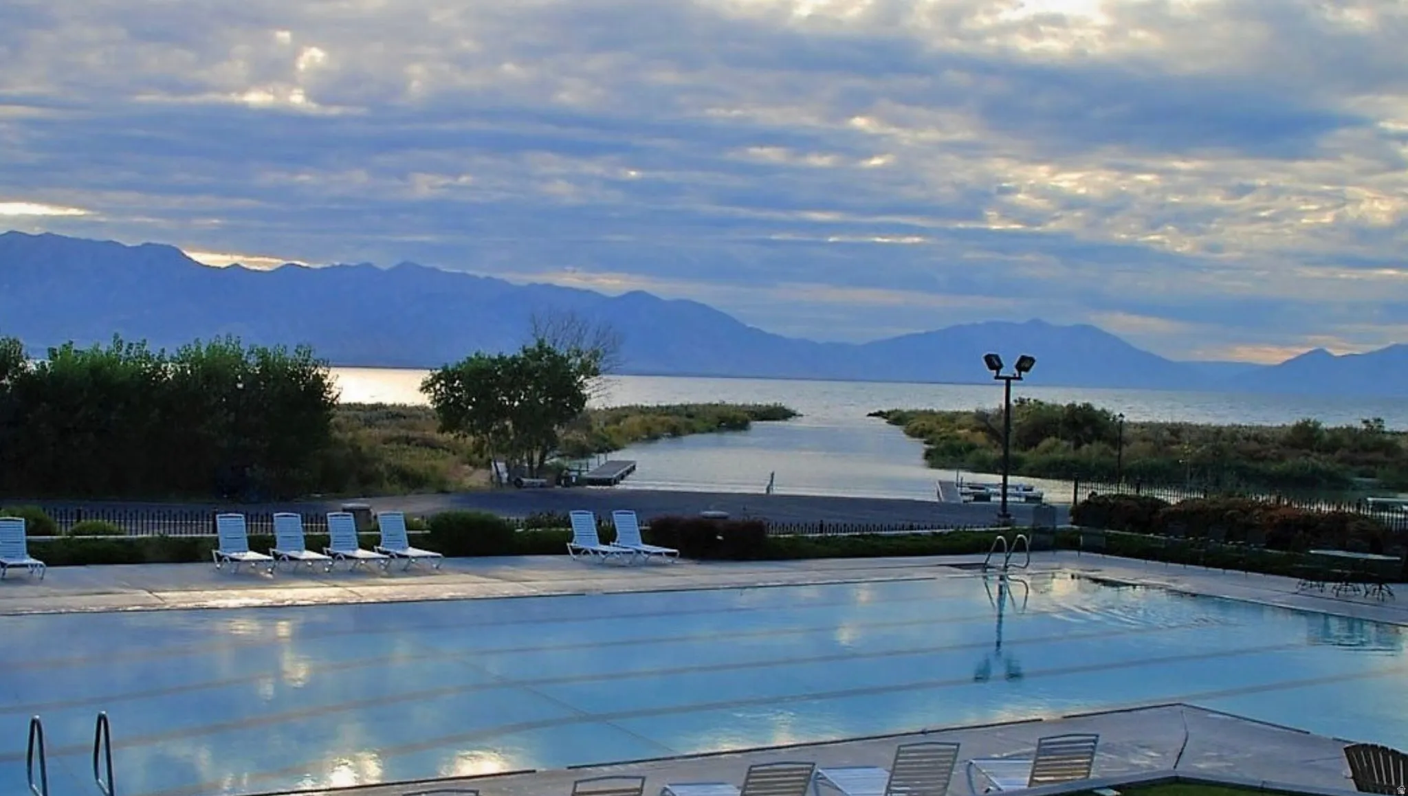 Community pool featuring a mountain view and a patio
