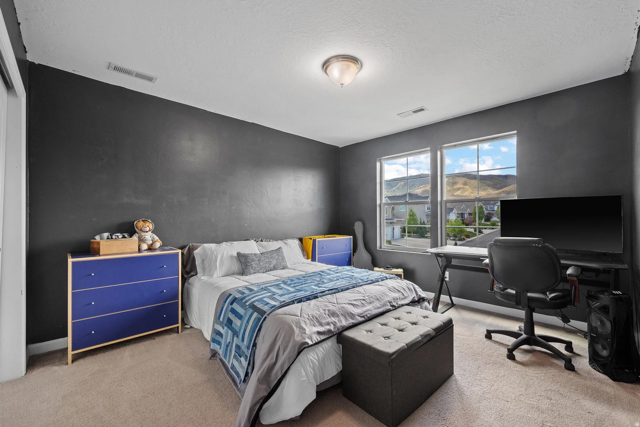 Bedroom featuring light carpet
