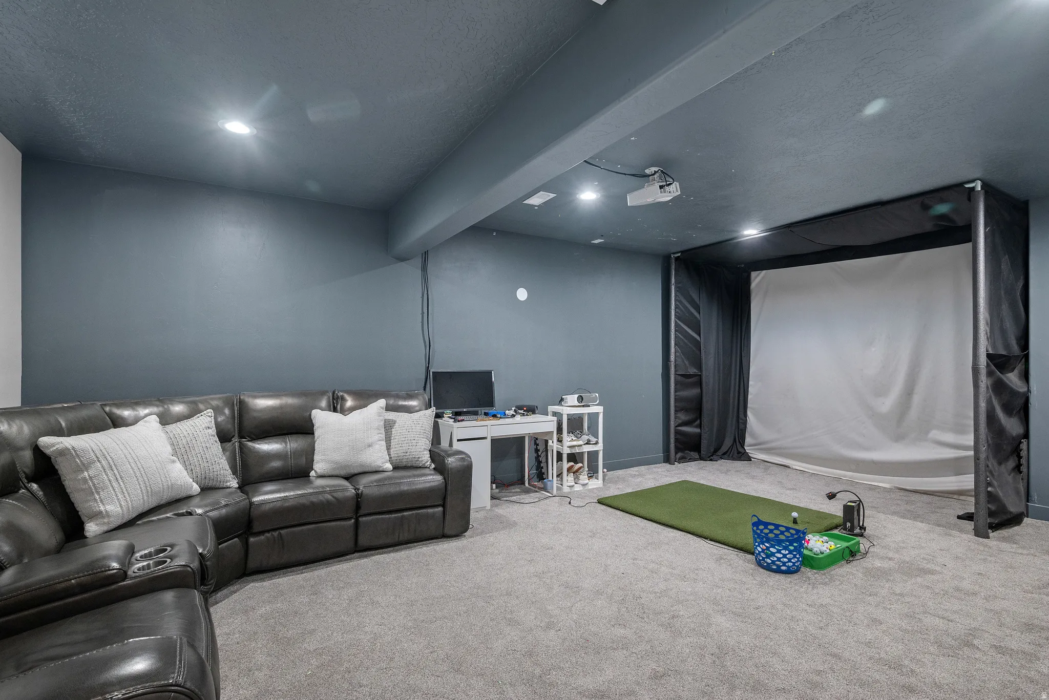 Theater room featuring a textured ceiling and recessed lighting, set up for golf sim and future wet bar