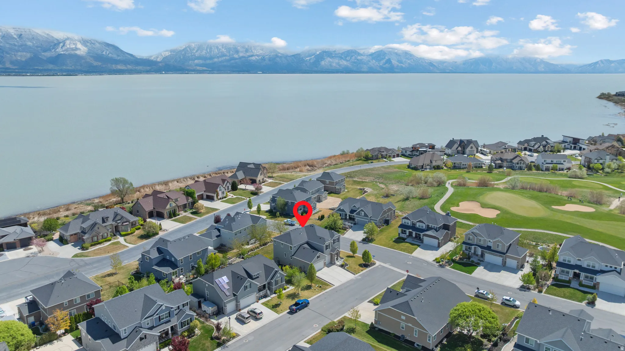 Aerial perspective of suburban area with a water and mountain view