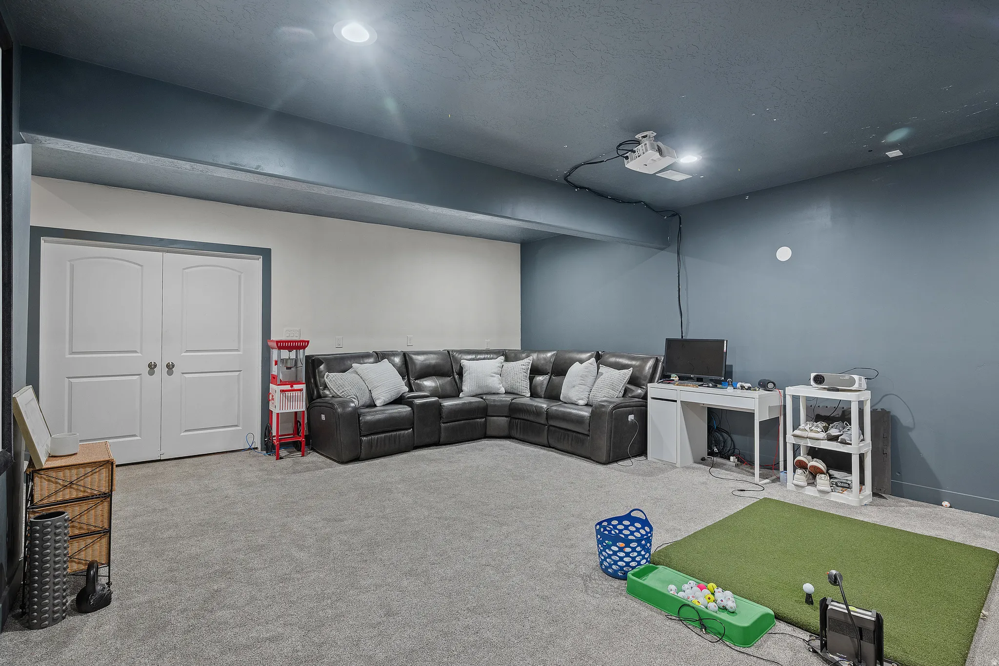 Theater room featuring a textured ceiling and recessed lighting, set up for golf sim and future wet bar