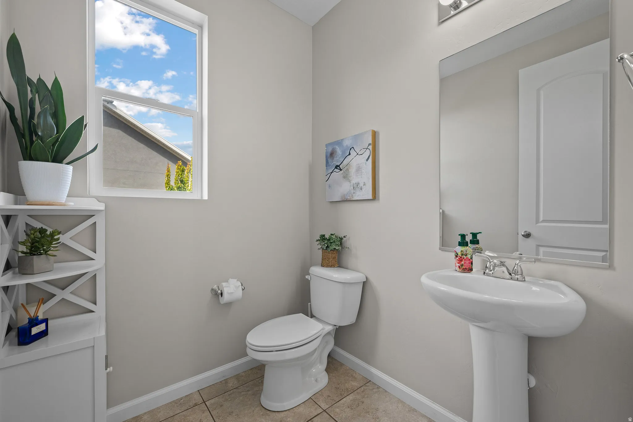 Half bath featuring toilet and light tile patterned floors