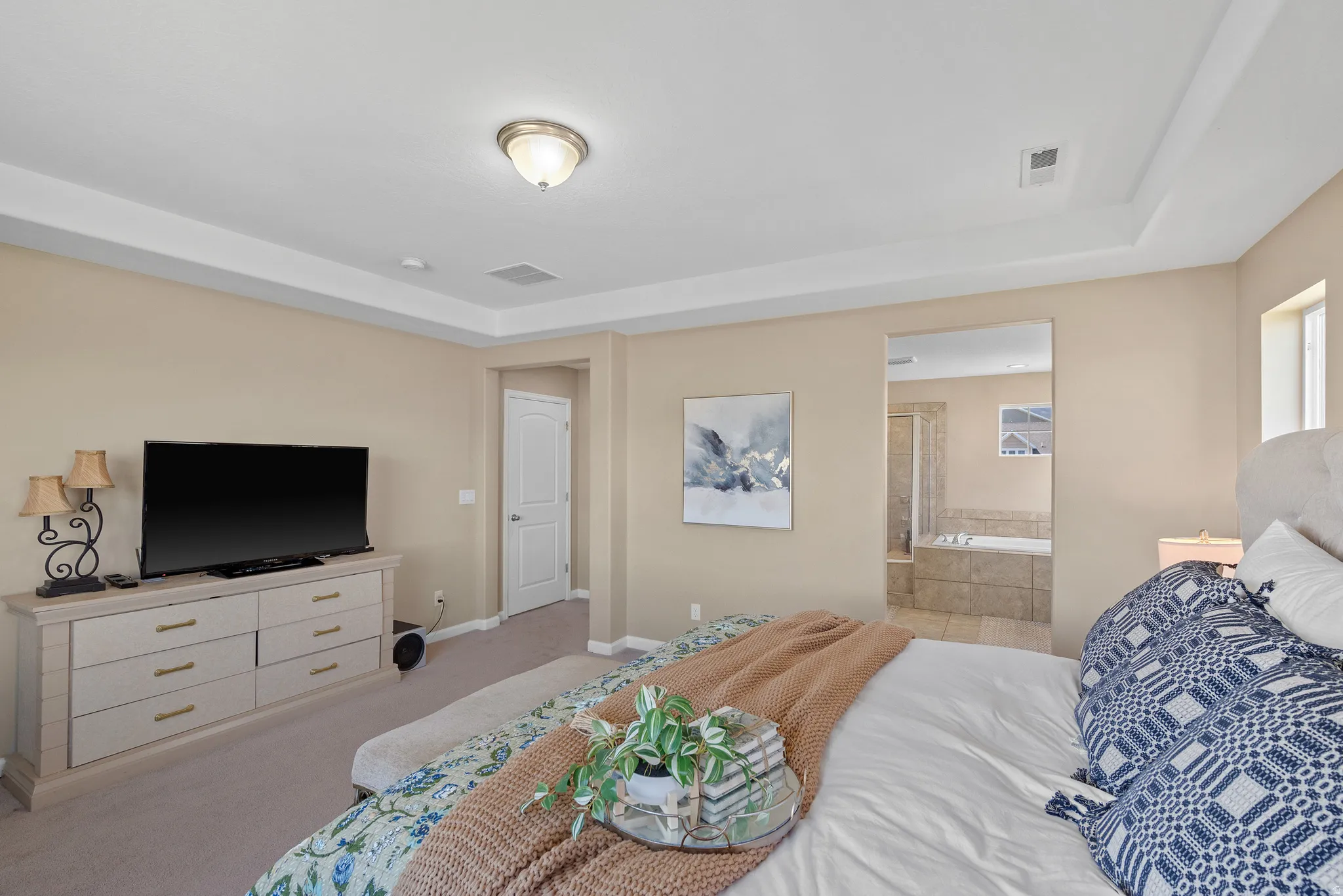 Primary Bedroom Suite with a tray ceiling