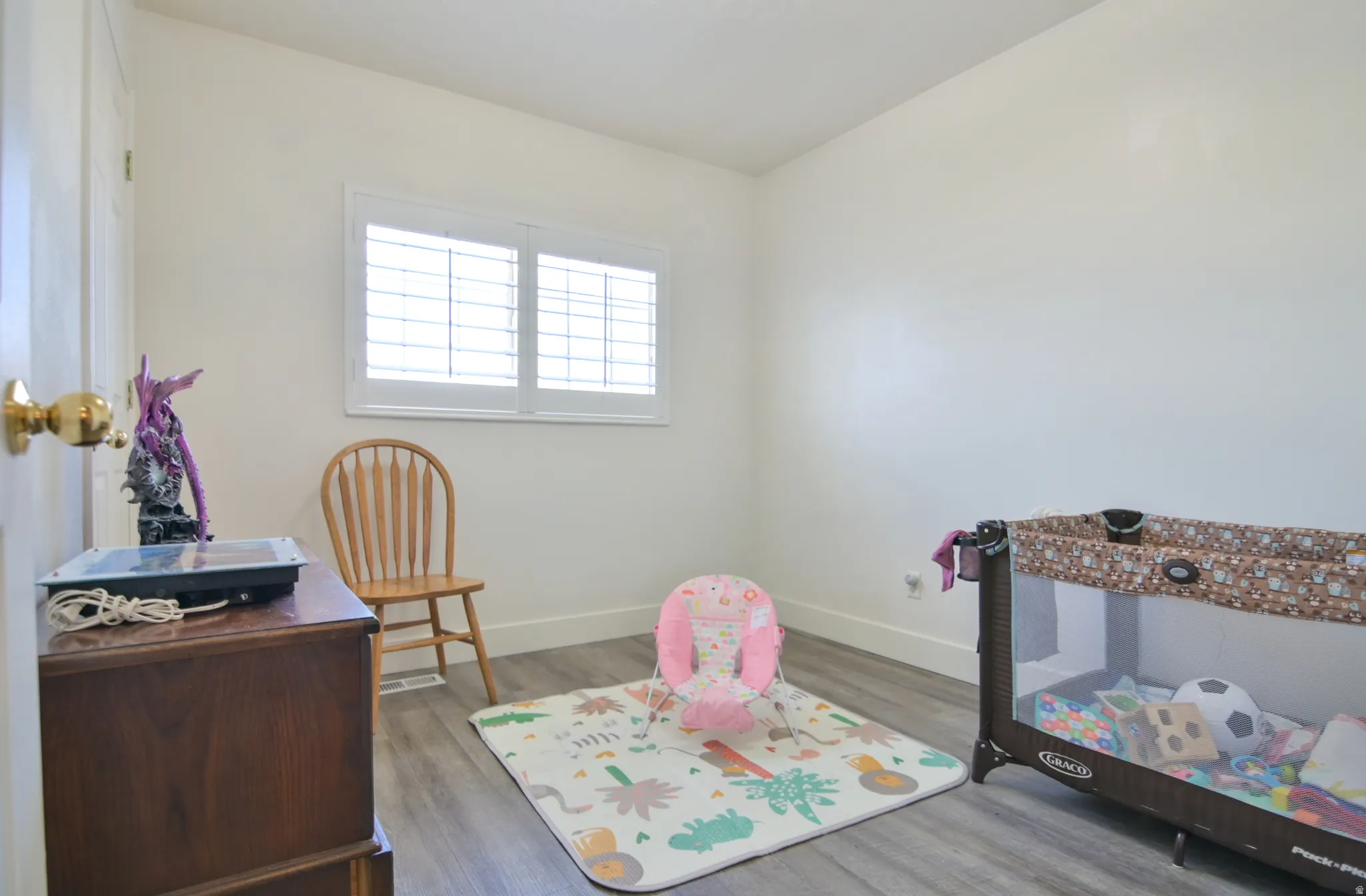 Rec room featuring baseboards and wood finished floors