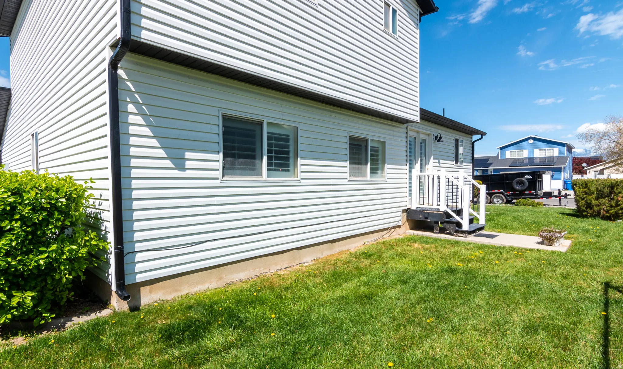 View of side of home featuring a yard