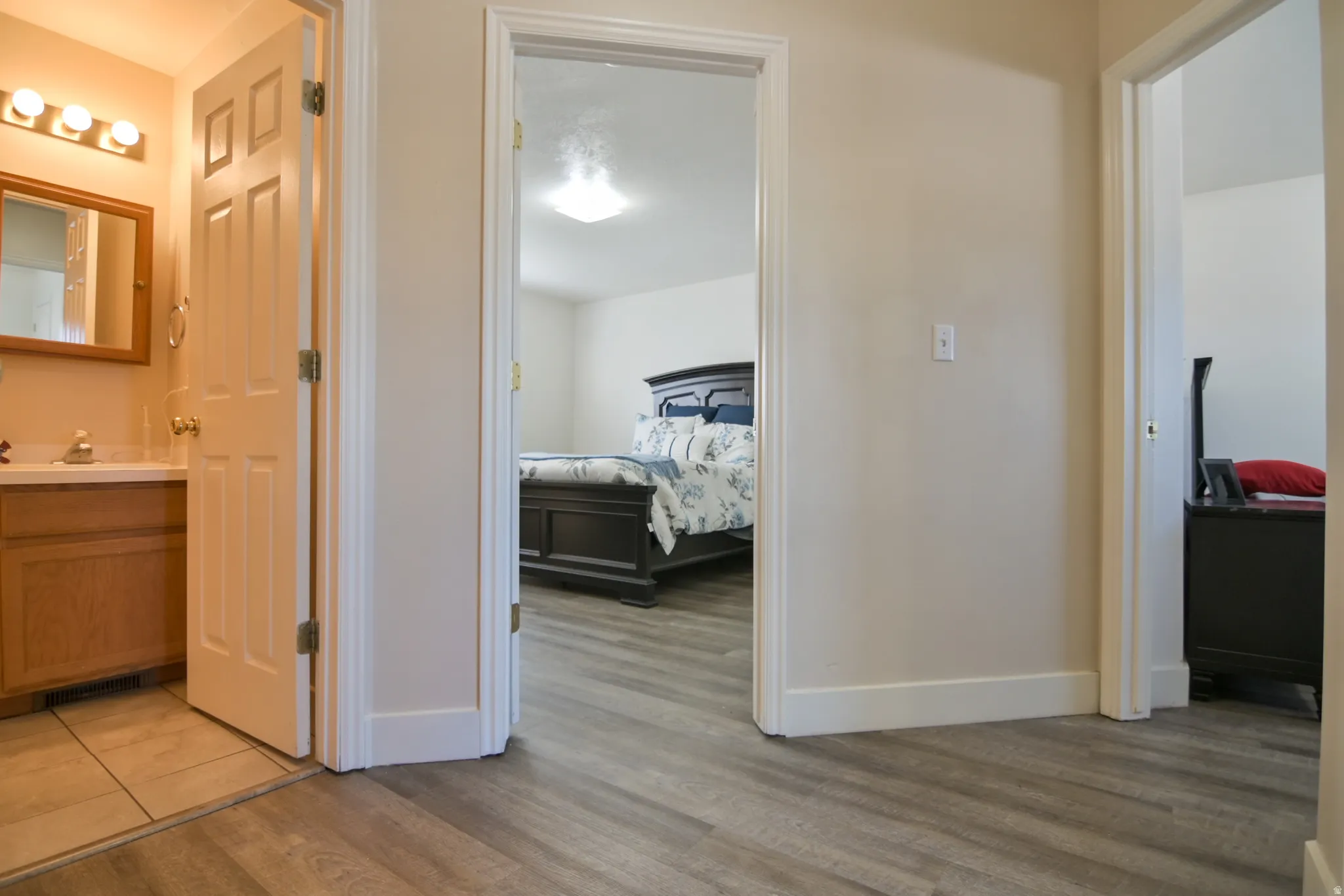 Hall with light wood-type flooring and baseboards