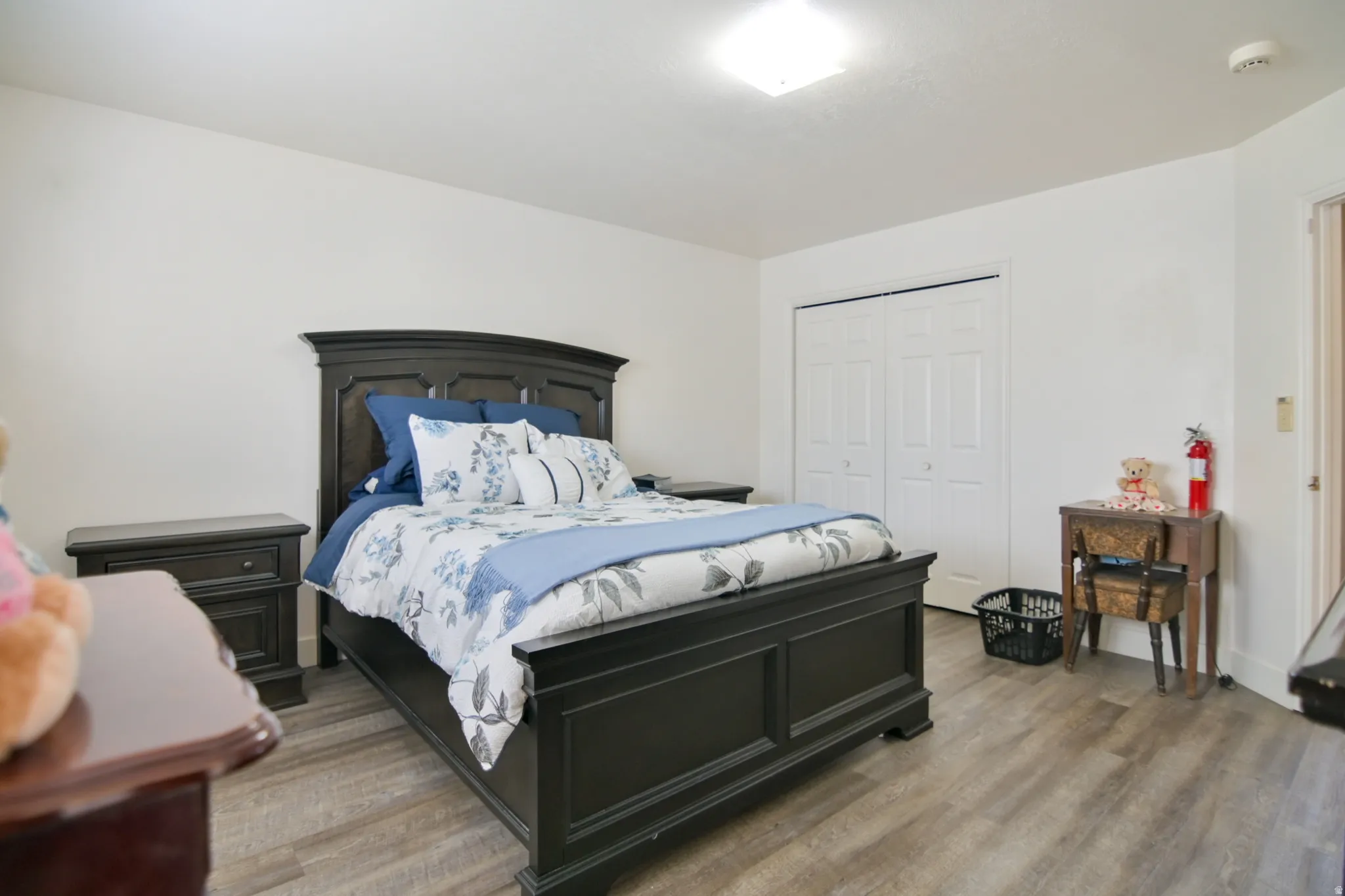 Bedroom featuring wood finished floors and a closet