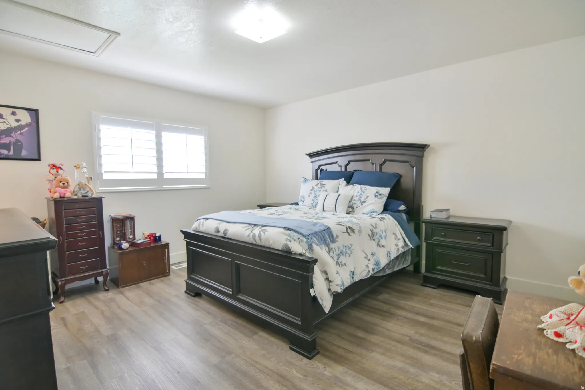 Bedroom featuring wood finished floors and baseboards